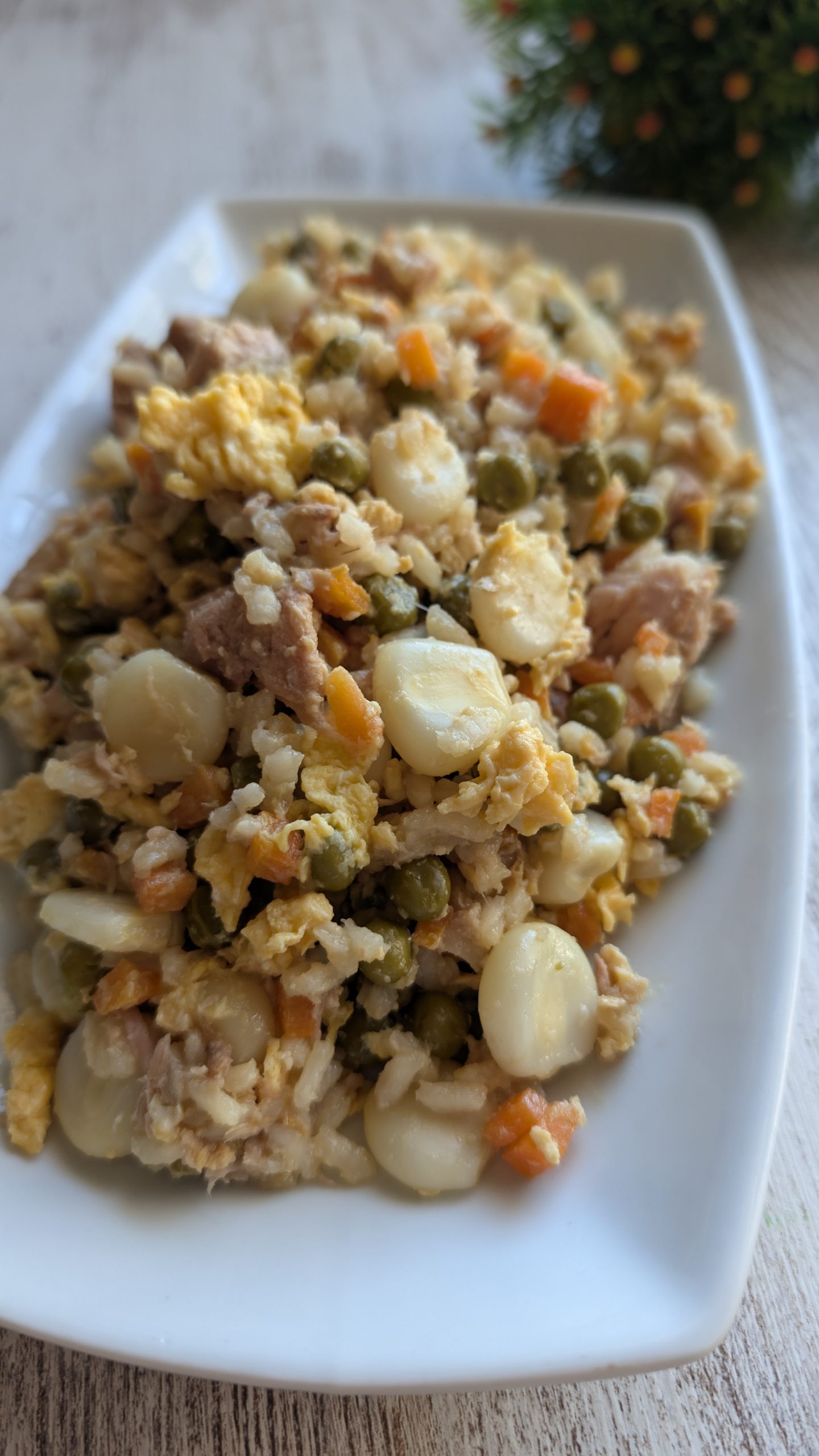 Plato de arroz tres delicias salteado con zanahoria, guisantes, maíz, tortilla y atún al natural.